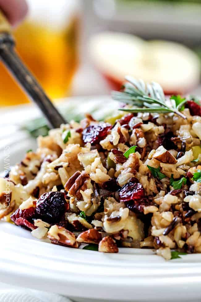Easy one pot Cranberry Apple Pecan Rice Pilaf simmered in herb seasoned chicken broth and apple juice and riddled with sweet dried cranberries, apples and roasted pecans for an unbelievable savory sweet side dish perfect for the holidays. Everyone always asks for this recipe! 