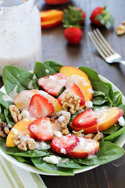 Spinach Salad with strawberries, peaches, candied walnuts, goat cheese and a crazy good (and crazy easy) homemade poppyseed dressing!